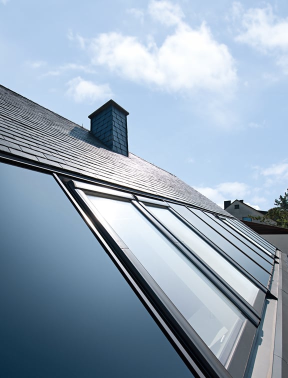 Dachausschnitt mit Indach-Photovoltaikanlage und Dachfenstern kombiniert
